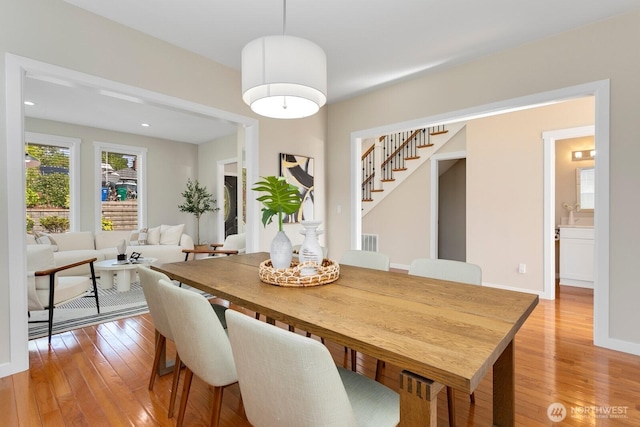 8441 8th Ave SW, Seattle, WA 98106 - dining room featuring light wood-type flooring and stairs