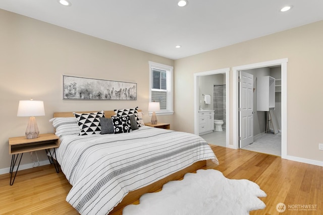 8441 8th Ave SW, Seattle, WA 98106 - bedroom featuring light wood-type flooring, connected bathroom, recessed lighting, and a walk in closet