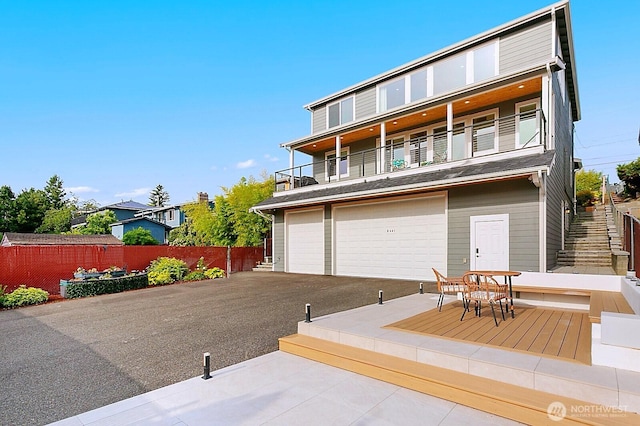 8441 8th Ave SW, Seattle, WA 98106 - back of house featuring a balcony and an attached garage