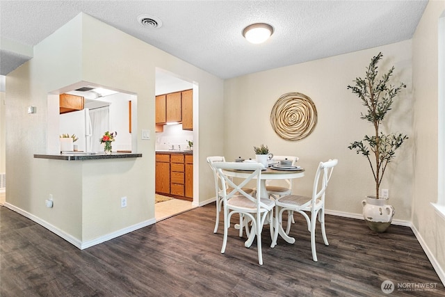 3100 Bill Mcdonald Pkwy Unit E101, Bellingham, WA 98225 - dining space featuring dark wood-type flooring and a textured ceiling