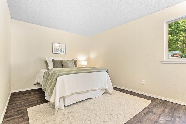 3100 Bill Mcdonald Pkwy Unit E101, Bellingham, WA 98225 - bedroom with baseboards and wood finished floors