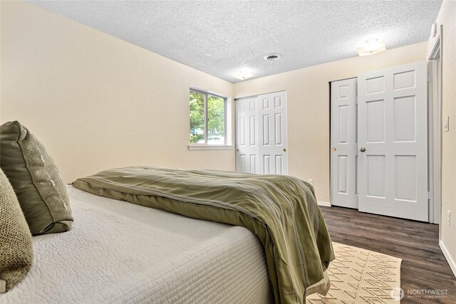 3100 Bill Mcdonald Pkwy Unit E101, Bellingham, WA 98225 - bedroom with dark wood-style flooring and a textured ceiling