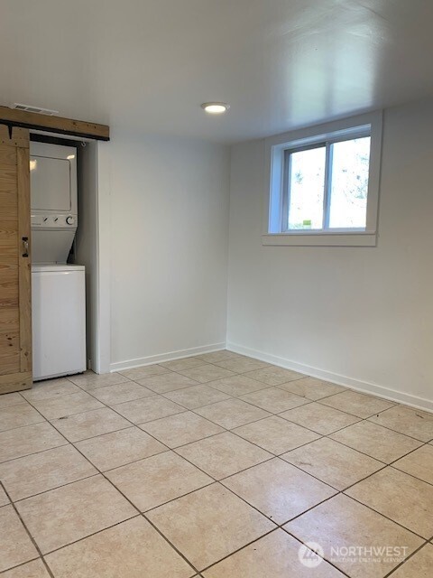 9928 Yakima Ave S, Tacoma, WA 98444 - basement featuring stacked washer / drying machine and light tile patterned flooring