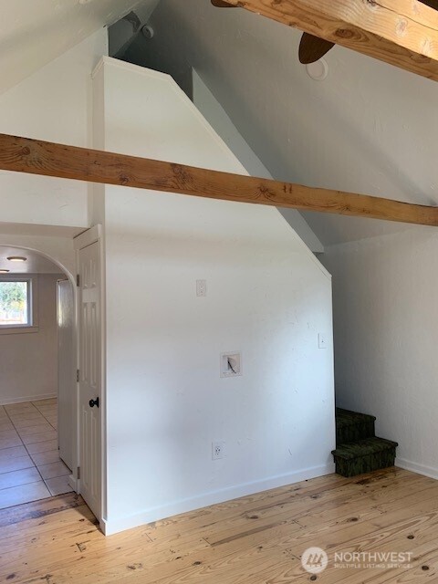 9928 Yakima Ave S, Tacoma, WA 98444 - additional living space with arched walkways, light wood-style flooring, and vaulted ceiling