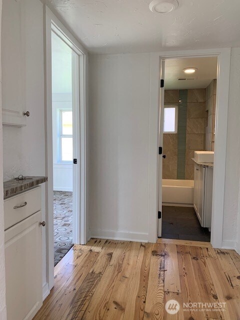 9928 Yakima Ave S, Tacoma, WA 98444 - corridor with light wood-style flooring and healthy amount of natural light