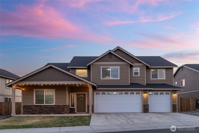 2303 N Middlecrest Dr, Ellensburg, WA 98926 - view of front facade featuring stone siding, driveway, and an attached garage