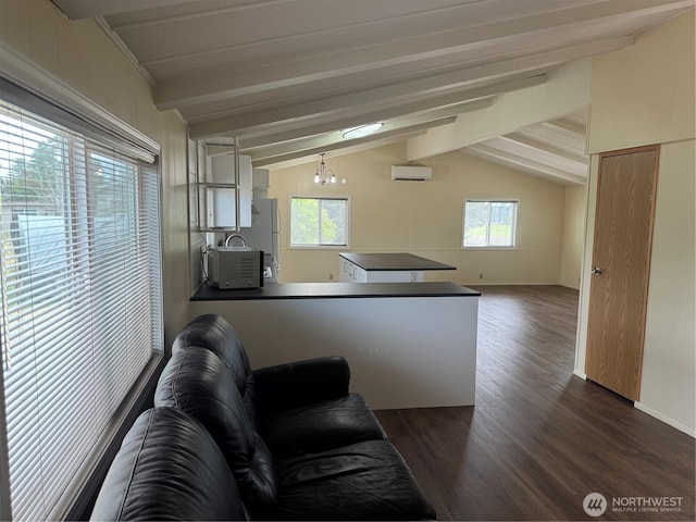 31 House Rd, Sequim, WA 98382 - living area featuring dark wood-style floors, a wall mounted air conditioner, and healthy amount of natural light