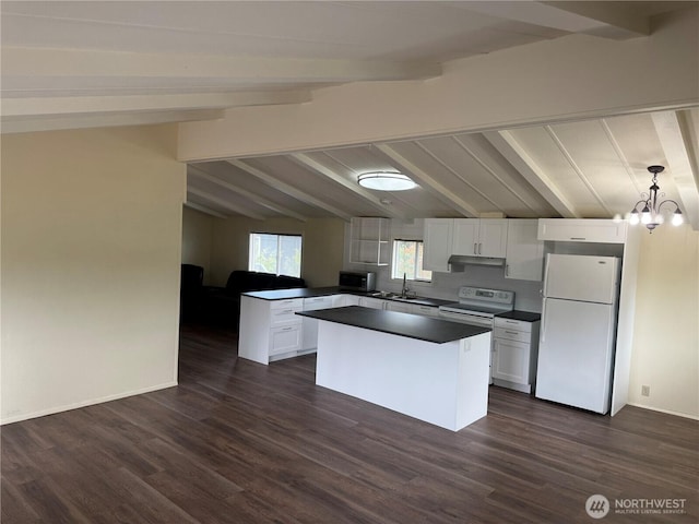31 House Rd, Sequim, WA 98382 - kitchen with white appliances, dark countertops, white cabinets, a peninsula, and under cabinet range hood