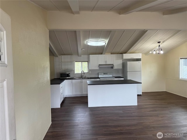 31 House Rd, Sequim, WA 98382 - kitchen featuring white appliances, dark countertops, beamed ceiling, under cabinet range hood, and white cabinets