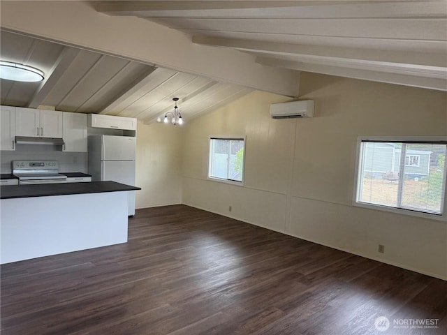 31 House Rd, Sequim, WA 98382 - kitchen with white appliances, a wall mounted AC, dark countertops, white cabinets, and under cabinet range hood