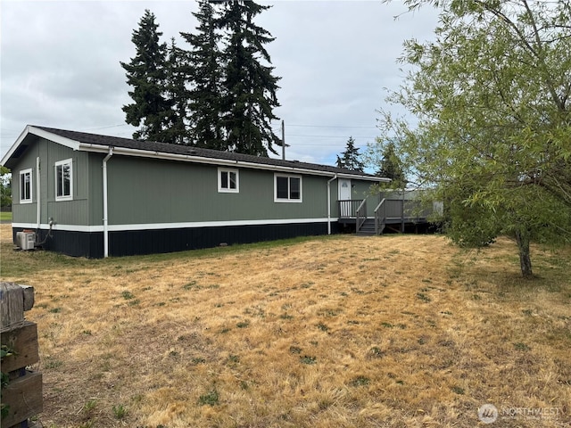 31 House Rd, Sequim, WA 98382 - rear view of house featuring a wooden deck and a lawn