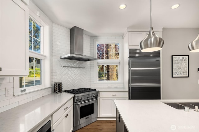 901 W Mcgraw St Unit 6, Seattle, WA 98119 - kitchen with high end appliances, wall chimney exhaust hood, light countertops, tasteful backsplash, and recessed lighting