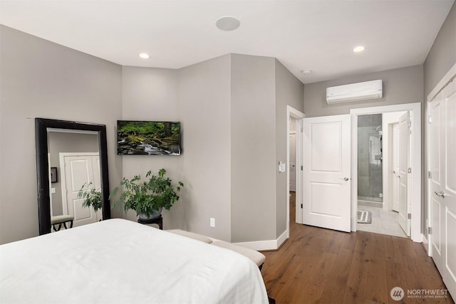 901 W Mcgraw St Unit 6, Seattle, WA 98119 - bedroom featuring an AC wall unit, dark wood-type flooring, recessed lighting, and ensuite bathroom