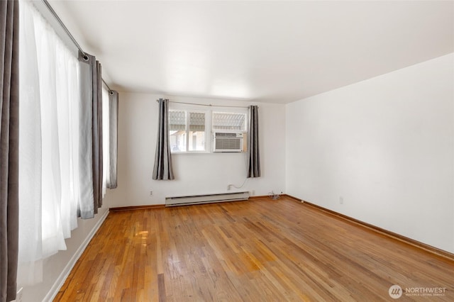 53 K St NE, Ephrata, WA 98823 - unfurnished room with baseboard heating, cooling unit, and light wood-style floors