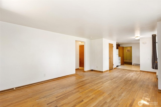 53 K St NE, Ephrata, WA 98823 - unfurnished room with light wood finished floors and a baseboard heating unit