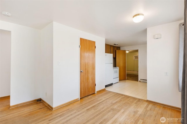53 K St NE, Ephrata, WA 98823 - spare room featuring a smoke detector, a baseboard radiator, and light wood finished floors