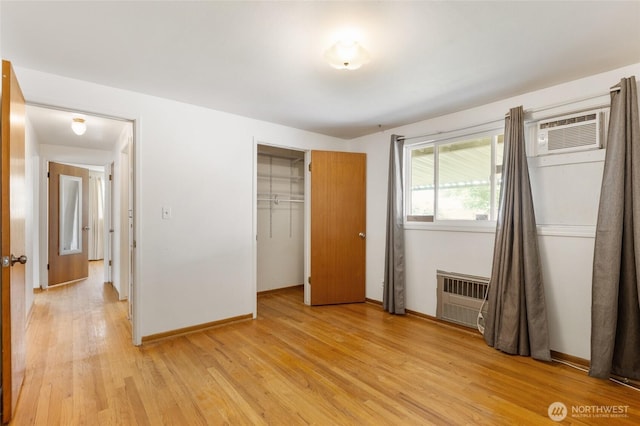 53 K St NE, Ephrata, WA 98823 - unfurnished bedroom with light wood finished floors, a wall mounted air conditioner, and a closet