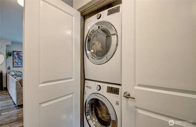 1651SW Mulberry St Unit E304, Oak Harbor, WA 98277 - laundry room featuring stacked washing machine and dryer and wood finished floors