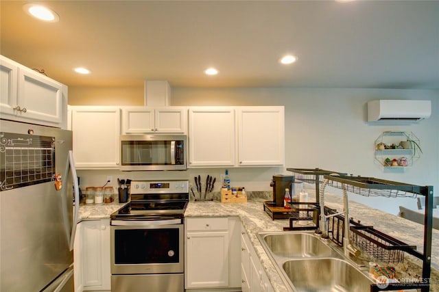 1651SW Mulberry St Unit E304, Oak Harbor, WA 98277 - kitchen featuring stainless steel appliances, a wall mounted air conditioner, white cabinetry, and recessed lighting