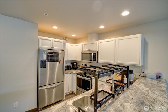1651SW Mulberry St Unit E304, Oak Harbor, WA 98277 - kitchen featuring stainless steel appliances, white cabinets, recessed lighting, and light stone countertops