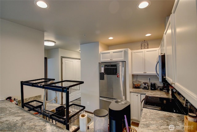 1651SW Mulberry St Unit E304, Oak Harbor, WA 98277 - kitchen with fridge, stainless steel microwave, range with electric stovetop, white cabinets, and recessed lighting
