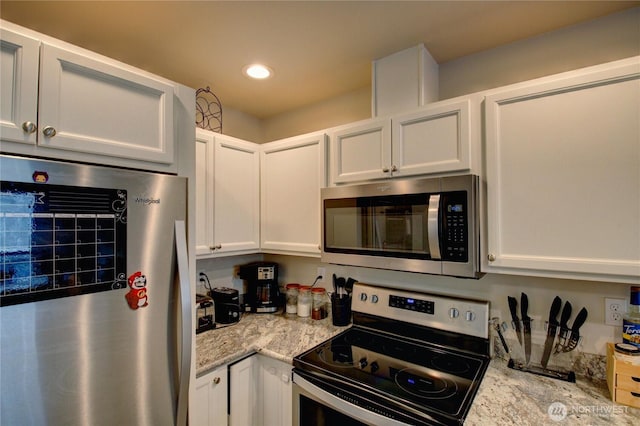 1651SW Mulberry St Unit E304, Oak Harbor, WA 98277 - kitchen featuring stainless steel appliances, white cabinetry, recessed lighting, and light stone countertops