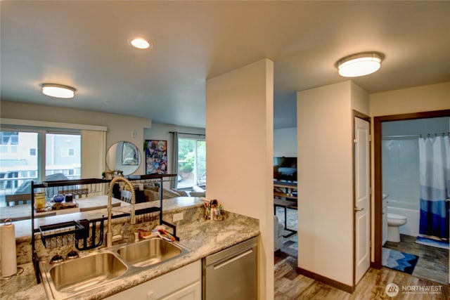 1651SW Mulberry St Unit E304, Oak Harbor, WA 98277 - kitchen featuring stainless steel dishwasher, light wood finished floors, and white cabinetry