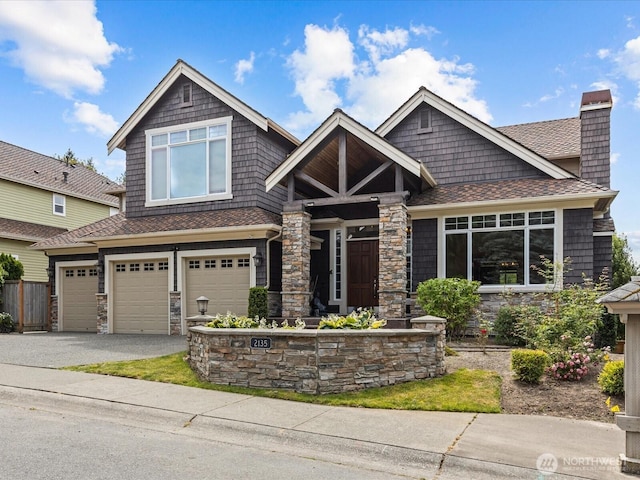 2135 204th Pl NE, Sammamish, WA 98074 - craftsman house with stone siding, a garage, asphalt driveway, a chimney, and a shingled roof