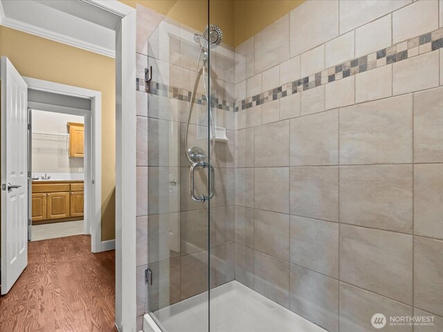 2135 204th Pl NE, Sammamish, WA 98074 - bathroom featuring a shower stall, wood finished floors, vanity, and crown molding