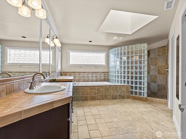 2135 204th Pl NE, Sammamish, WA 98074 - bathroom featuring a bath, double vanity, plenty of natural light, and a walk in shower