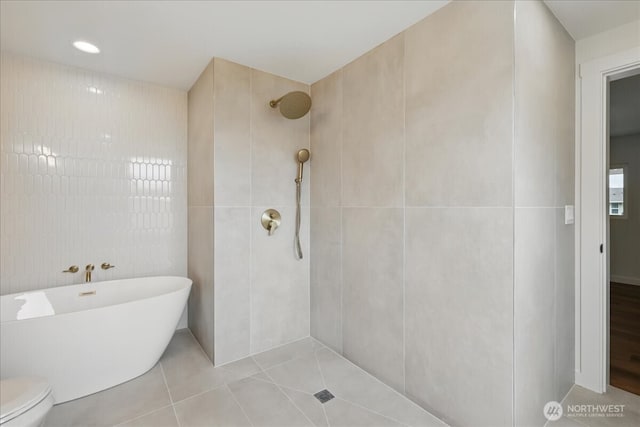 40 E Robert Pl, Sequim, WA 98382 - bathroom featuring tile walls, tiled shower, a freestanding bath, and tile patterned flooring