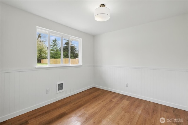 40 E Robert Pl, Sequim, WA 98382 - empty room with wood finished floors and a wainscoted wall