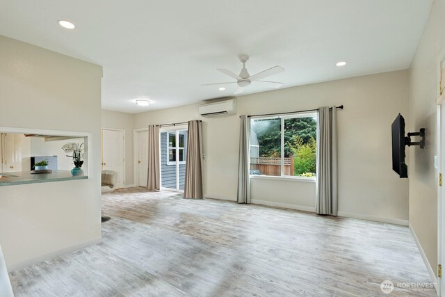 27902 69th Ave NW, Stanwood, WA 98292 - unfurnished living room featuring a wall mounted AC, plenty of natural light, wood finished floors, ceiling fan, and recessed lighting
