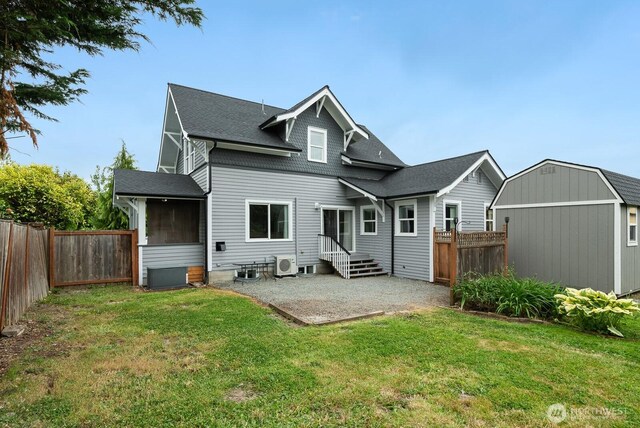 27902 69th Ave NW, Stanwood, WA 98292 - back of house with a patio, a fenced backyard, a sunroom, and a storage unit