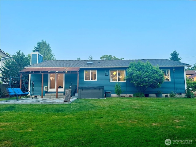 4313 131st St SE, Everett, WA 98208 - back of property with a hot tub, a patio area, a yard, and a chimney