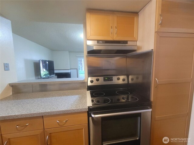 33010 17th Pl S Unit A-108, Federal Way, WA 98003 - kitchen featuring stainless steel range with electric stovetop, under cabinet range hood, light countertops, lofted ceiling, and a textured ceiling