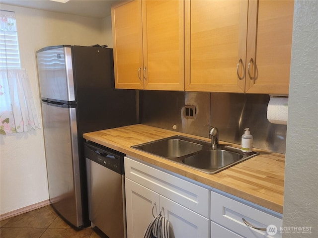 33010 17th Pl S Unit A-108, Federal Way, WA 98003 - kitchen with butcher block counters, stainless steel dishwasher, tile patterned flooring, and decorative backsplash