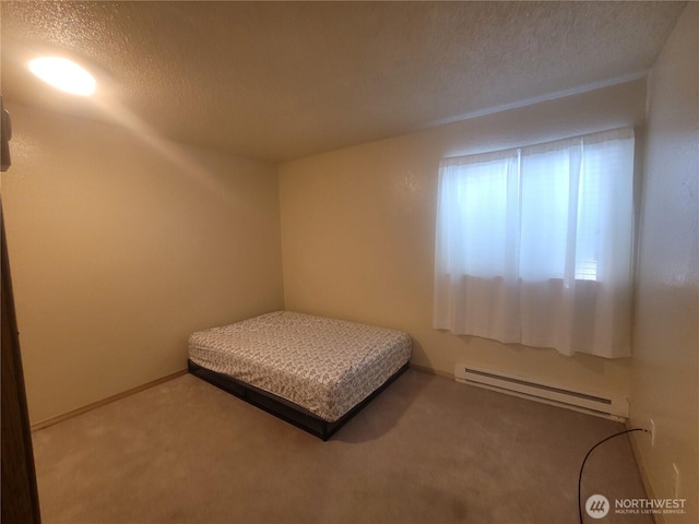 33010 17th Pl S Unit A-108, Federal Way, WA 98003 - carpeted bedroom featuring a baseboard radiator and a textured ceiling