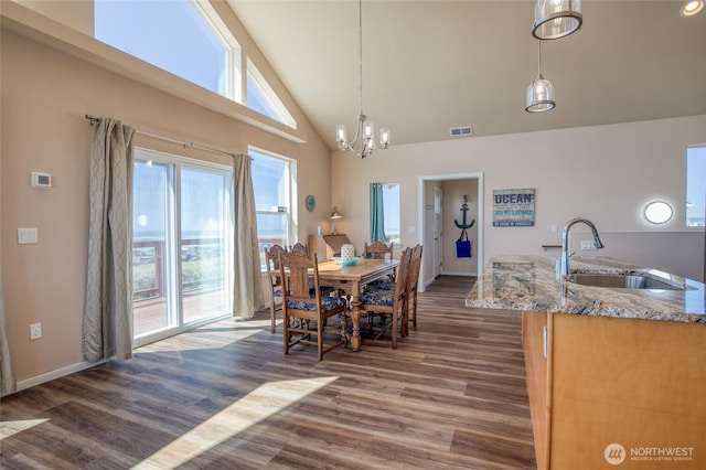 1511 E Ocean Shores Blvd SW, Ocean Shores, WA 98569 - dining space featuring dark wood finished floors, high vaulted ceiling, and a chandelier