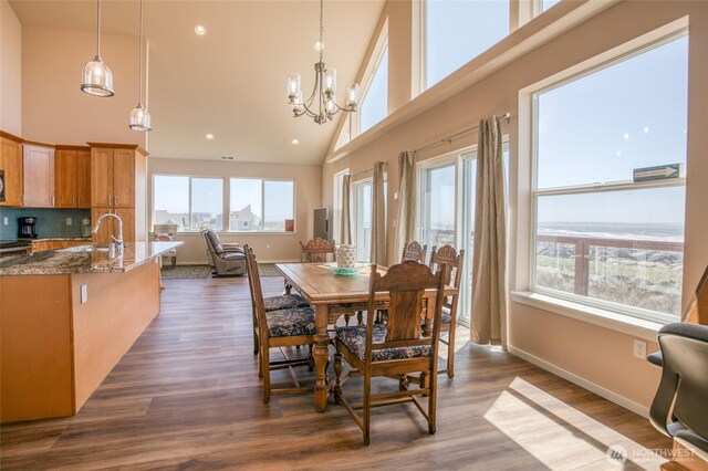 1511 E Ocean Shores Blvd SW, Ocean Shores, WA 98569 - dining room featuring high vaulted ceiling, a chandelier, dark wood-style flooring, and recessed lighting