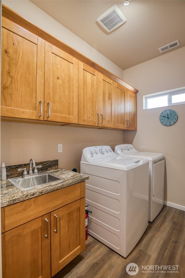 1511 E Ocean Shores Blvd SW, Ocean Shores, WA 98569 - laundry room featuring washer and clothes dryer, cabinet space, and dark wood finished floors