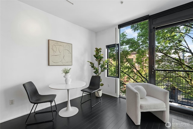 1111 E Pike St Unit 302, Seattle, WA 98122 - sitting room with healthy amount of natural light and dark wood finished floors