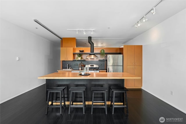 1111 E Pike St Unit 302, Seattle, WA 98122 - kitchen with stainless steel appliances, rail lighting, dark wood-style floors, and a kitchen bar