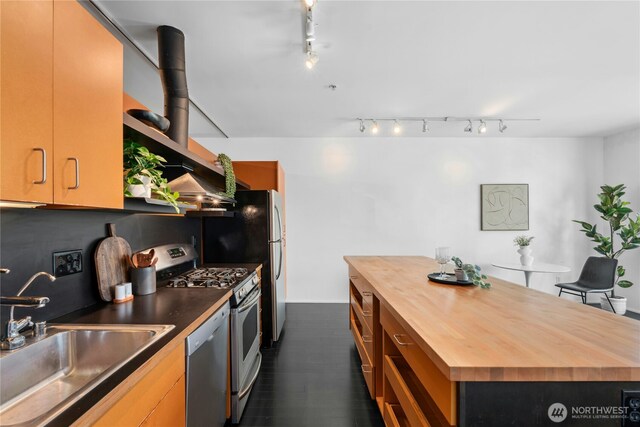 1111 E Pike St Unit 302, Seattle, WA 98122 - kitchen with butcher block counters, stainless steel appliances, track lighting, and dark wood-type flooring