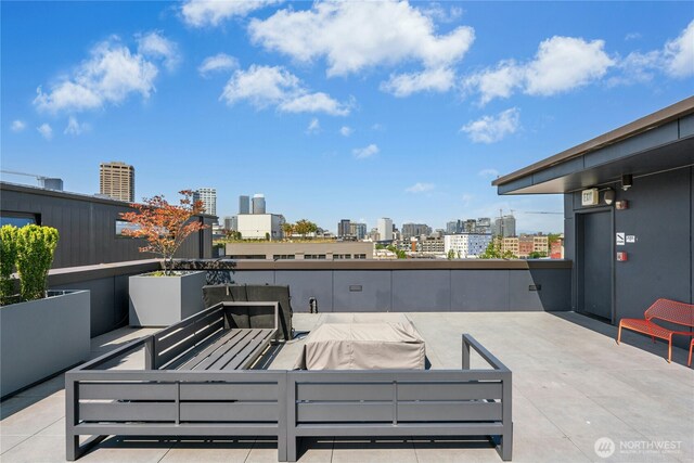 1111 E Pike St Unit 302, Seattle, WA 98122 - view of patio with a skyline view and an outdoor living space