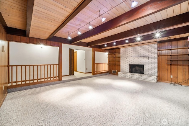 14000 NE 97th Ave, Vancouver, WA 98662 - unfurnished living room with a wooden ceiling with exposed beams, carpet, wooden walls, and a brick fireplace