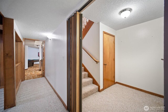 14000 NE 97th Ave, Vancouver, WA 98662 - hallway with a textured ceiling, light colored carpet, and stairway
