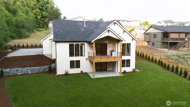 24018 Dolphin Ln, Mount Vernon, WA 98274 - rear view of property featuring a patio area, a lawn, board and batten siding, a balcony, and roof with shingles