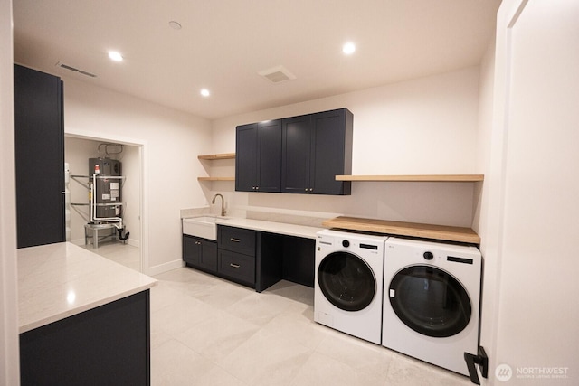 24018 Dolphin Ln, Mount Vernon, WA 98274 - washroom featuring washer and clothes dryer, water heater, cabinet space, and recessed lighting