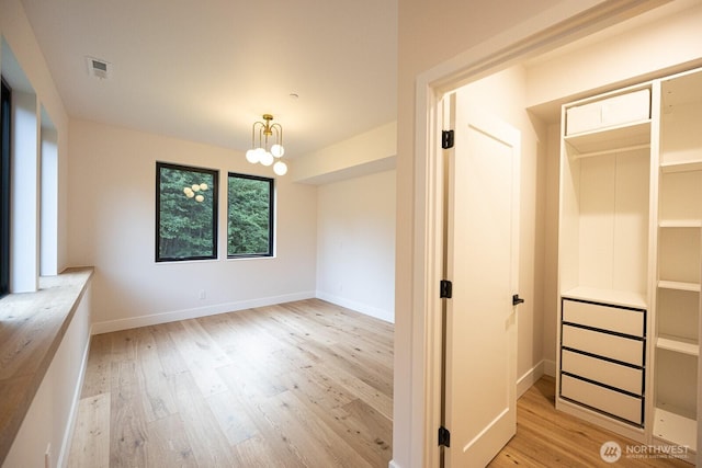 24018 Dolphin Ln, Mount Vernon, WA 98274 - unfurnished bedroom featuring wood finished floors and a chandelier